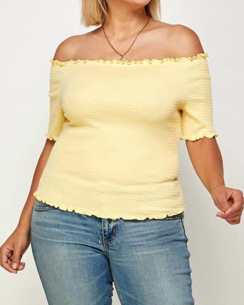 Front of a model wearing a size 2XL Off Shoulder Smocked Top in Mellow Yellow in Mellow Yellow by Haute Fox. | dia_product_style_image_id:327147